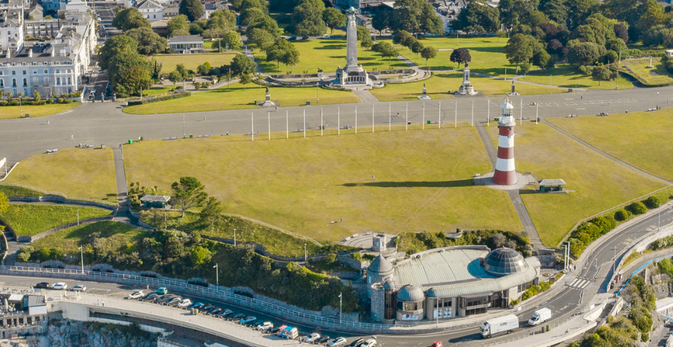 An aerial shot of Plymouth Hoe featuring Smeaton's Tower and The War Memorial